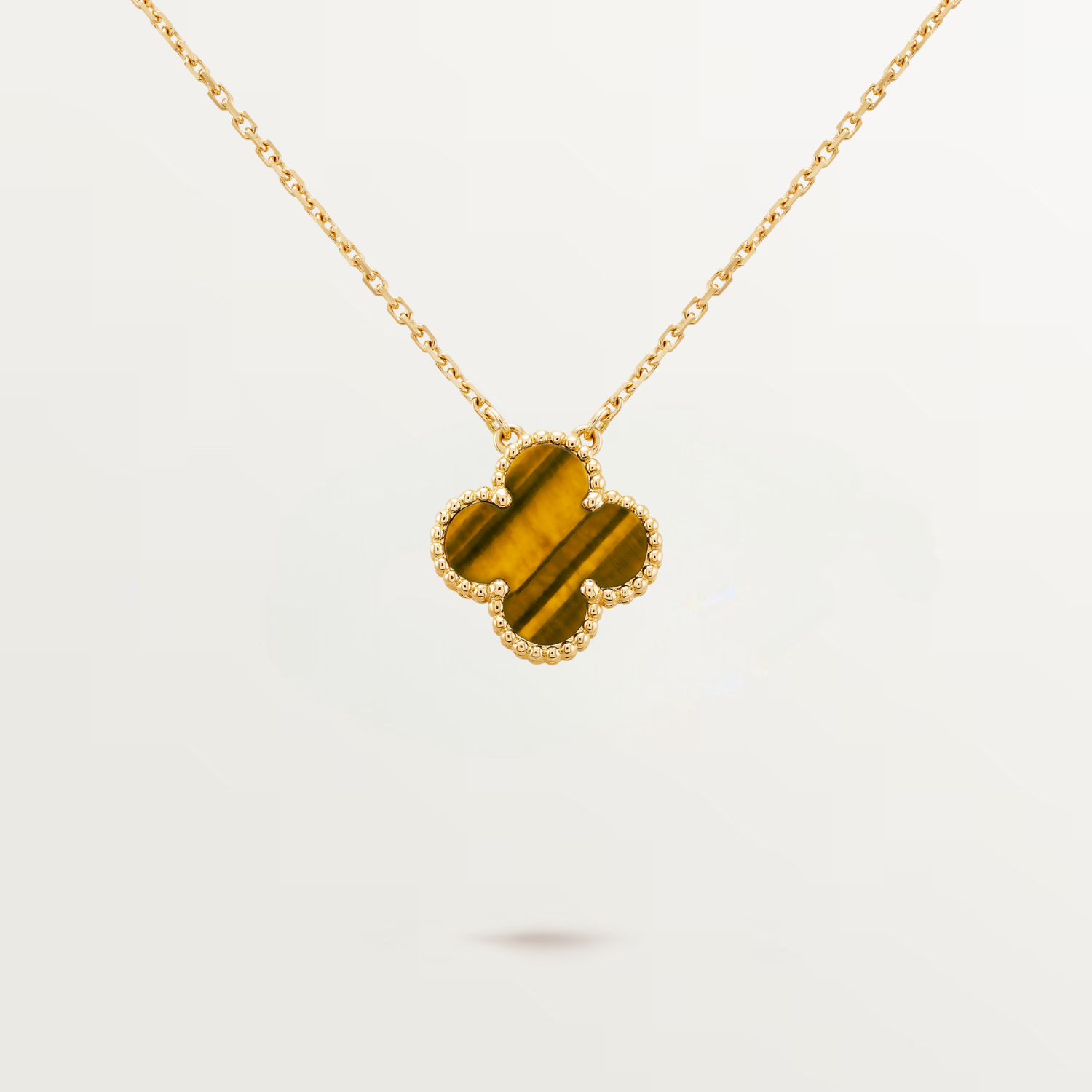 VINTAGE ALHAMBRA PENDANT, TIGER EYE, YELLOW GOLD